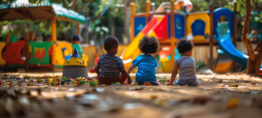 Children playing together on playground equipment at camp